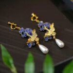 brinco de pressão azul e dourado grande oriental de passaro aadddd